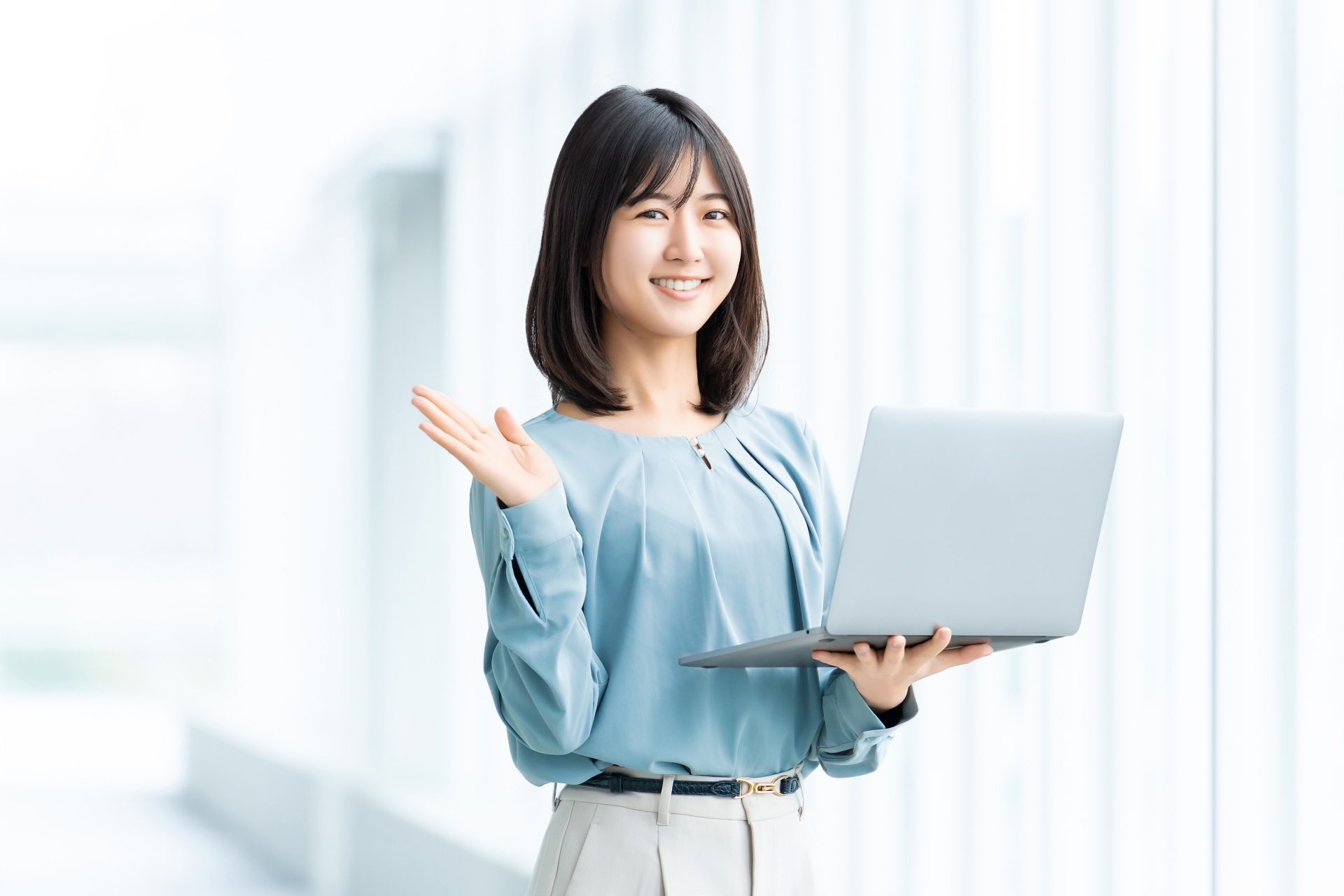 パソコンを手に載せる女性