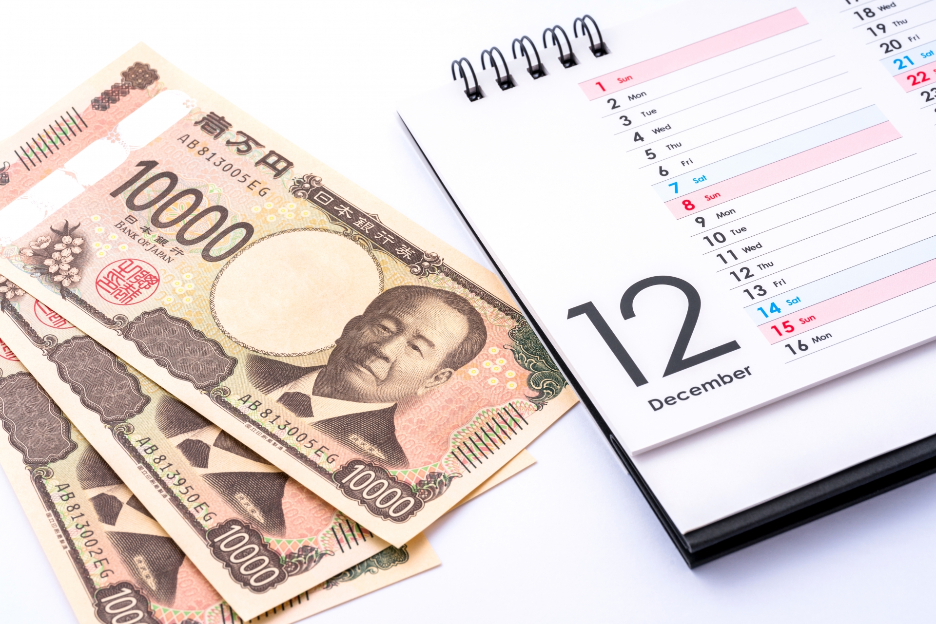12月のカレンダーと一万円札。